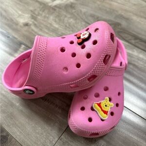 Kids size 13 pink crocs with 2 Disney jibbitz charms. Gently used!